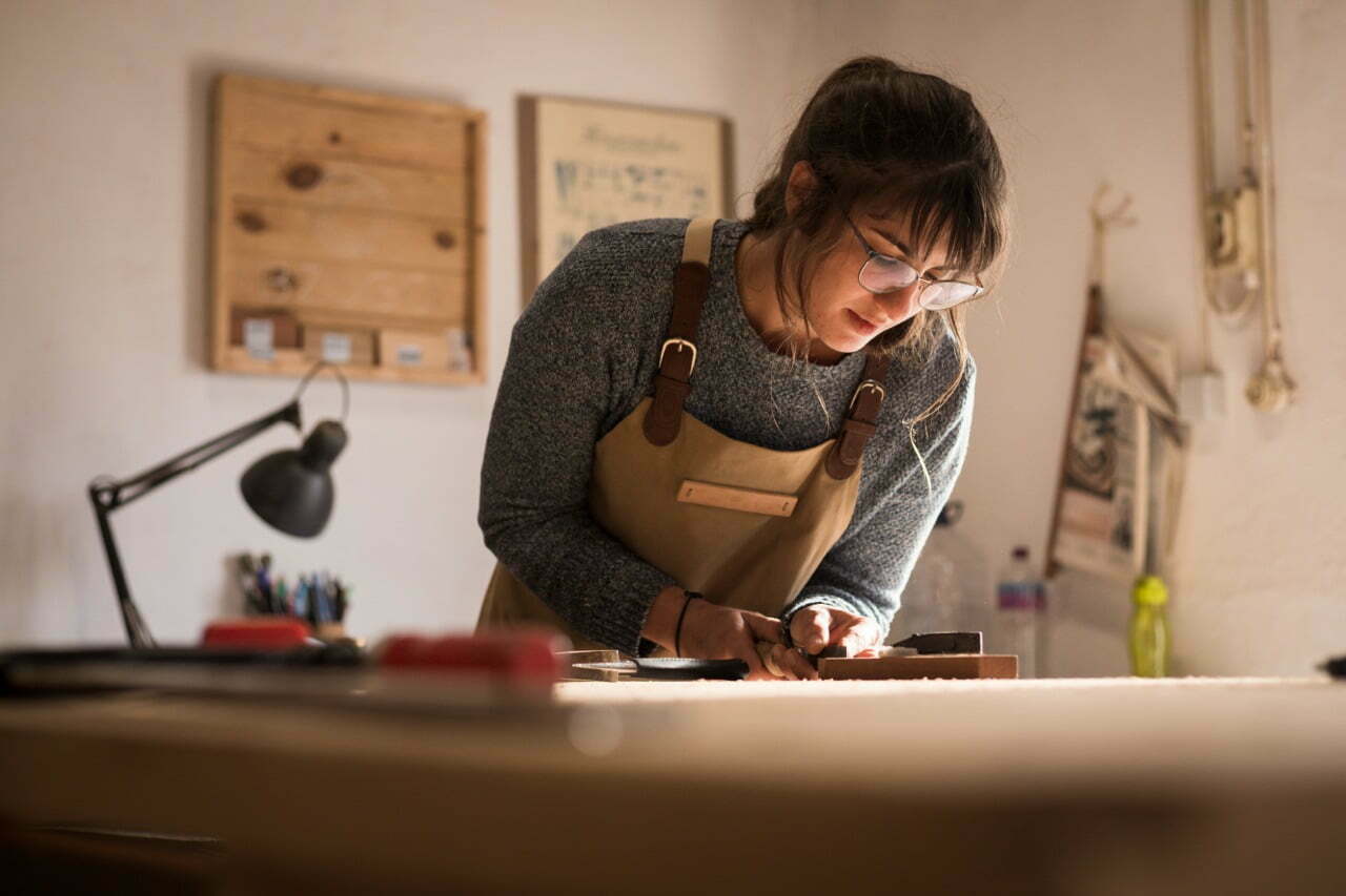 stock-photo-a-young-female-carpenter-working-as-wood-designer-in-a-small-carpentry-workshop-young-business-1824322379