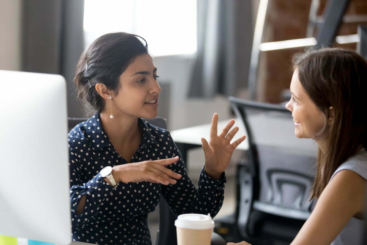 stock-photo-friendly-female-colleagues-having-good-relationships-pleasant-conversation-at-workplace-during-1246077505