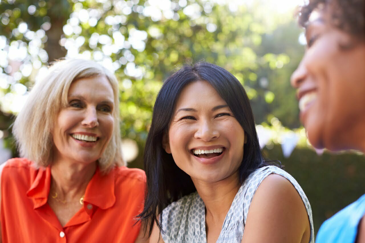 stock-photo-mature-female-friends-socializing-in-backyard-together-583329838