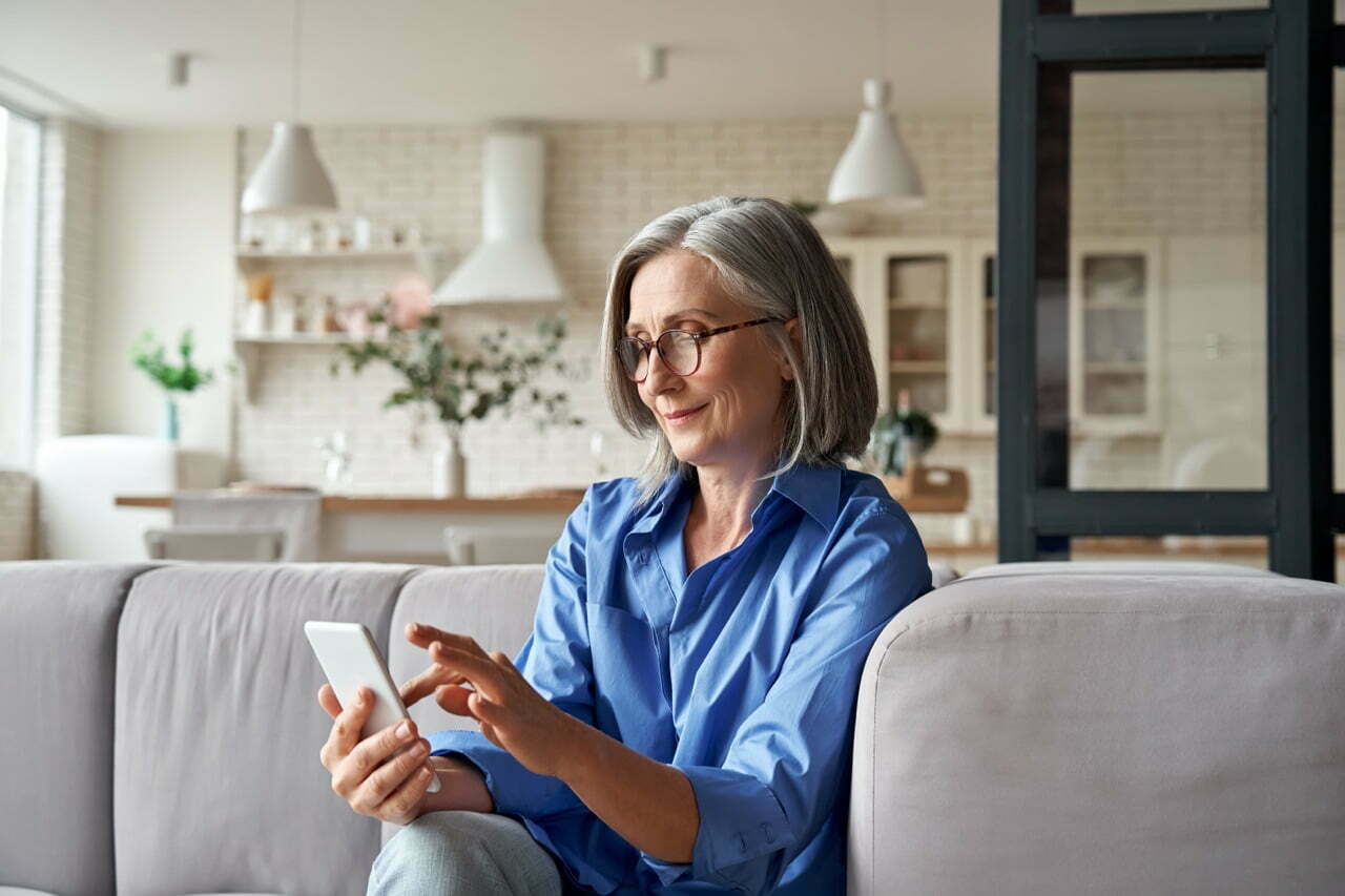stock-photo-relaxed-mature-old-s-woman-older-middle-aged-female-customer-holding-smartphone-using-mobile-app-1832160472